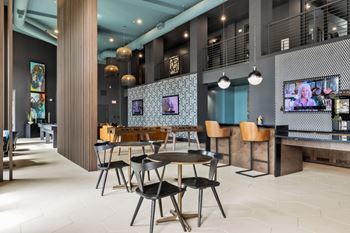 Gaming lounge with billiards, foosball, shuffleboard, and vintage arcade games